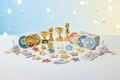 Premium kids reward pack with badges, stickers, and mini trophies arranged in a clean studio layout